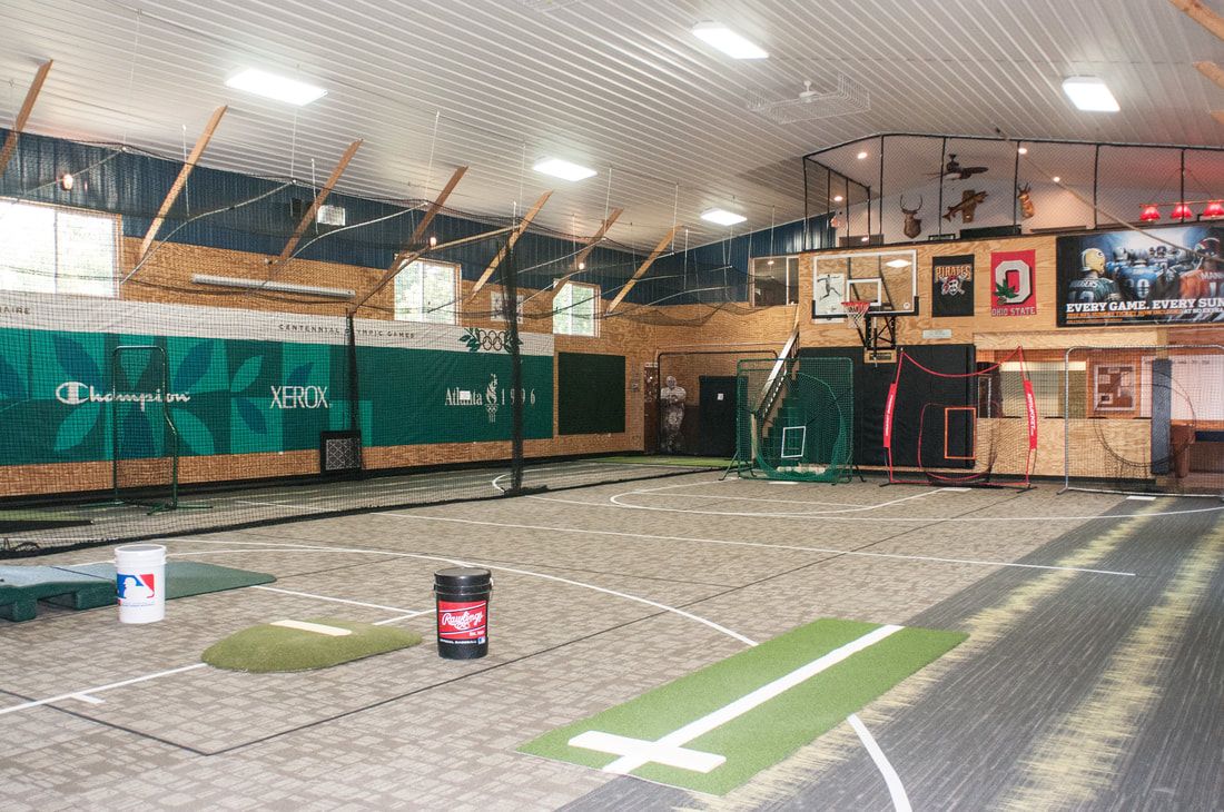 Indoor training facility with turf, pitching mound and batting area
