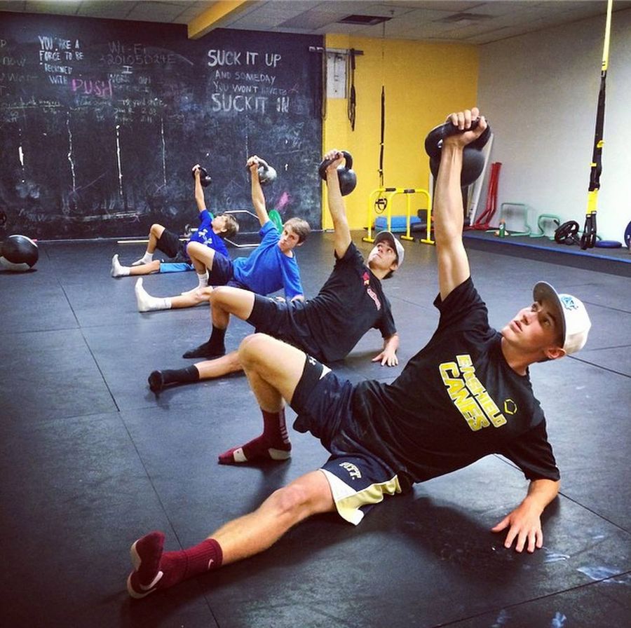 Athletes working through a mobility routine in the training room